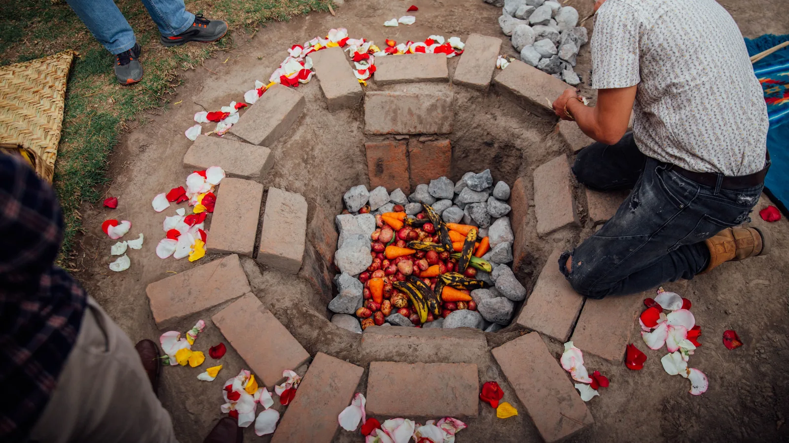 An earth oven lined with hot stones