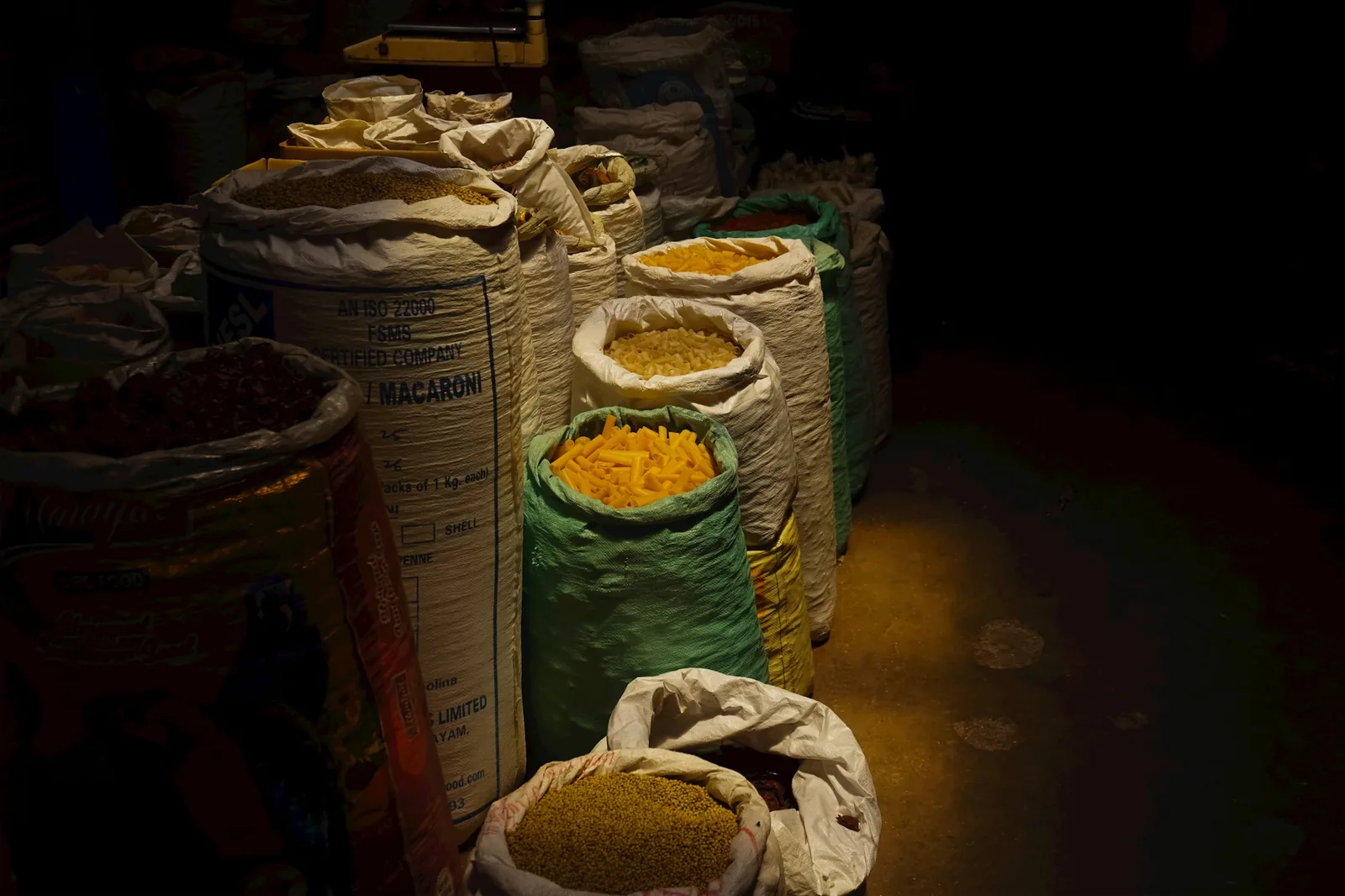 Sacks of different dried maize at a market
