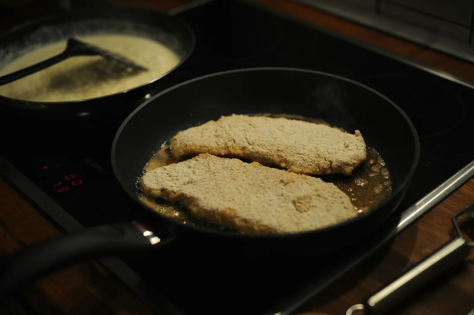 Battered fish frying golden