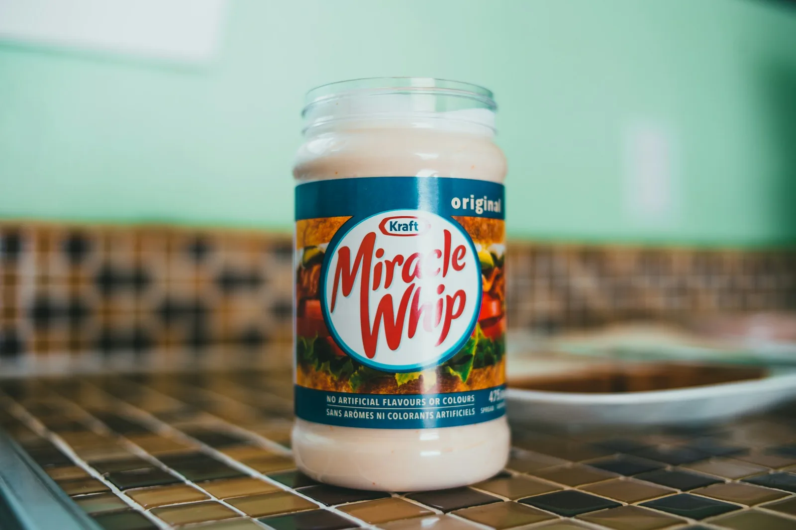 A pale creamy sauce in a squeeze bottle