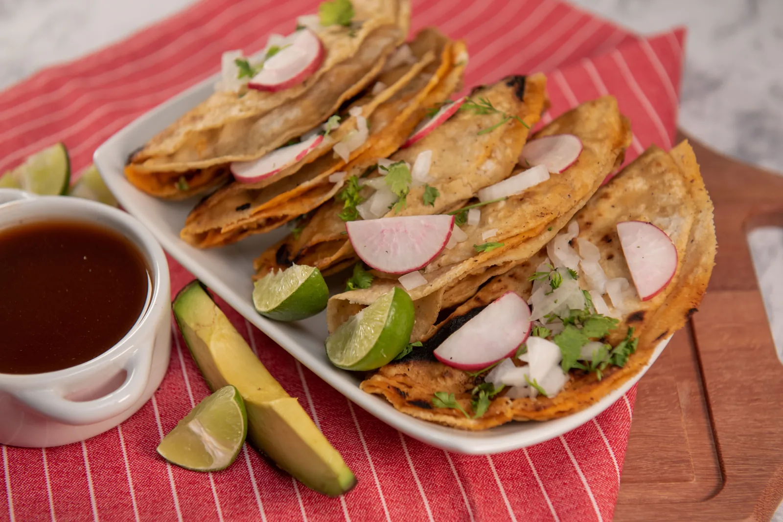Crisp cheese-filled birria tacos cooking on a griddle
