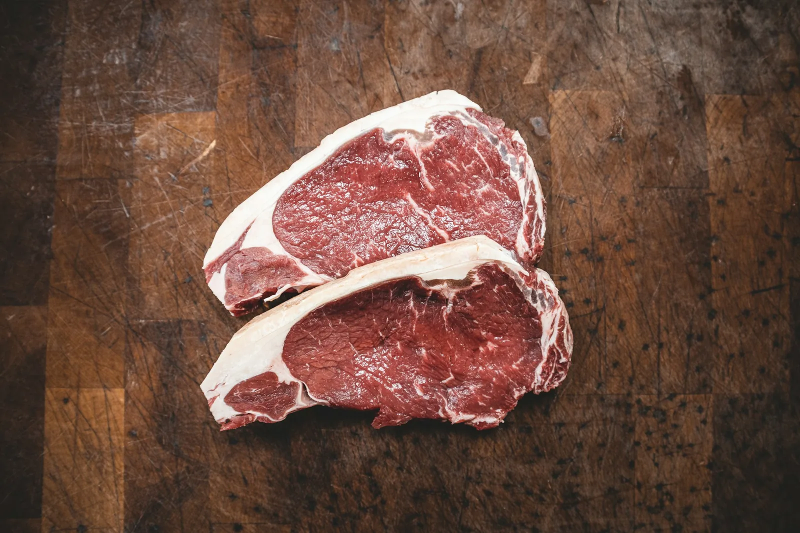 Thinly cut raw beef on a butcher's board