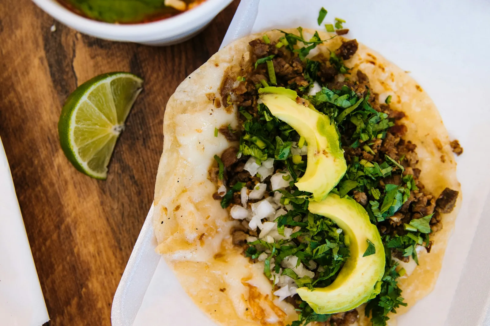 Chopped grilled beef in corn tortillas with onion and cilantro