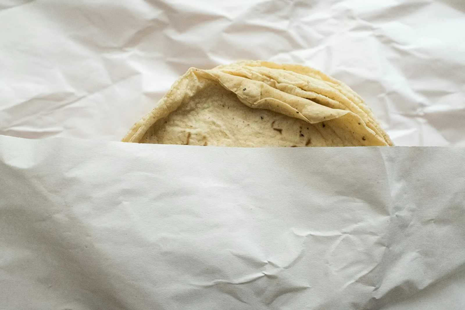 A burrito wrapped in a large flour tortilla