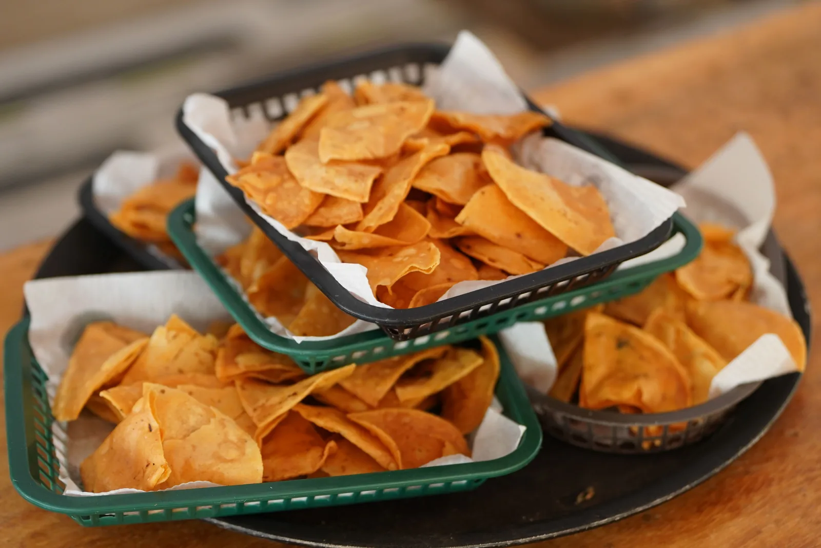 A stack of corn tortillas kept warm in a cloth-lined basket