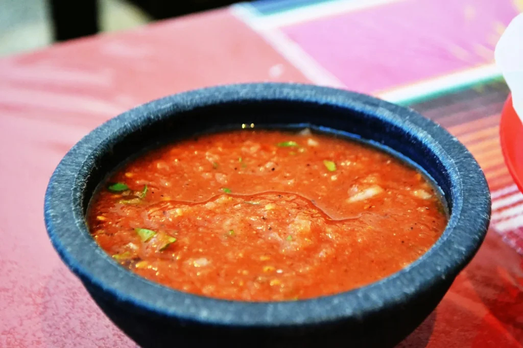 Small fried masa shells topped with salsa, meat and cheese