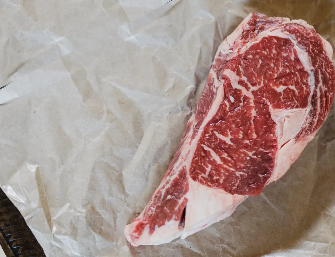 A cut of beef resting on butcher paper