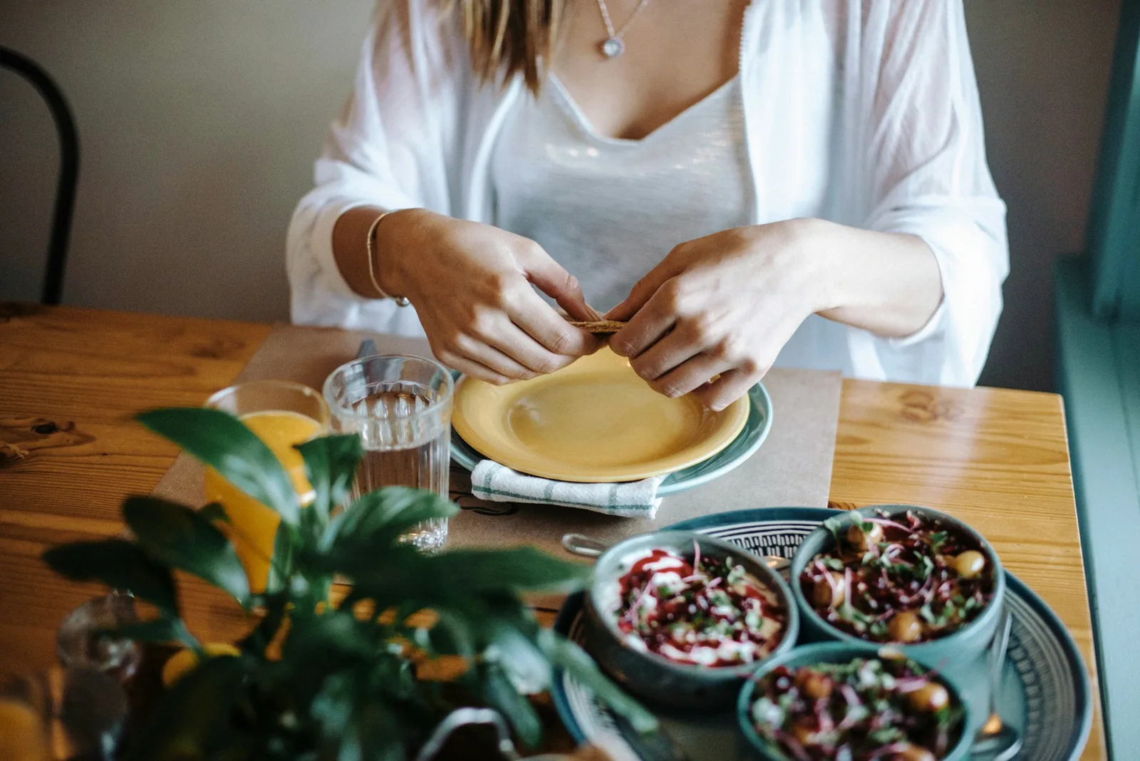 Filled tortillas being rolled before saucing