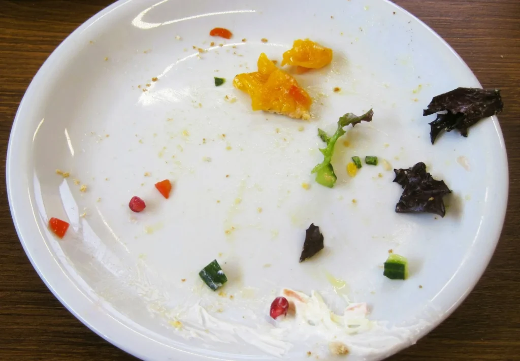 A taco that has split, spilling its filling