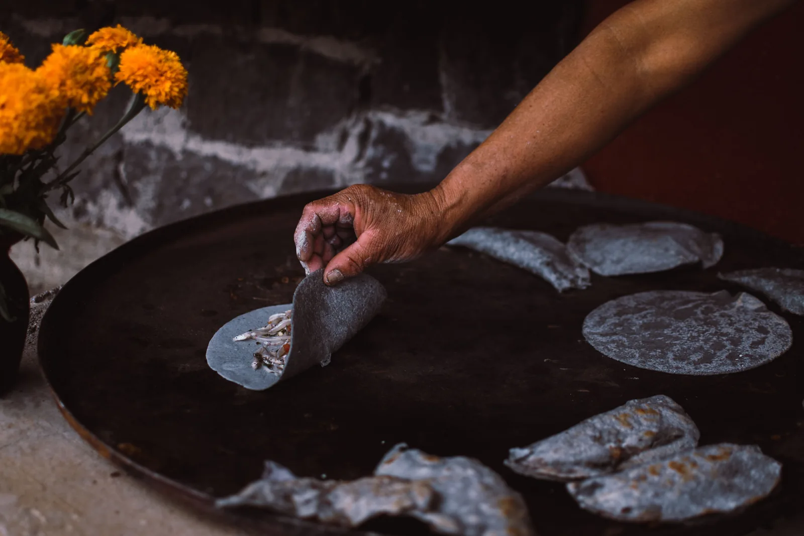 Corn tortillas warming on a dry griddle