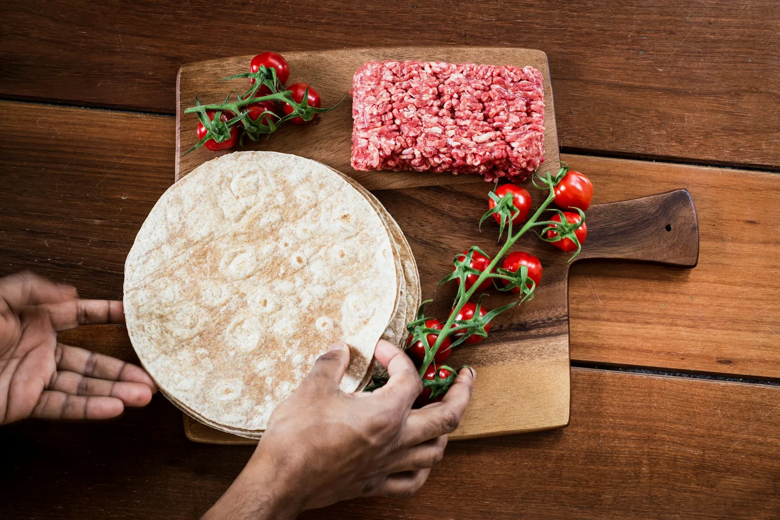 A tortilla being filled at the table