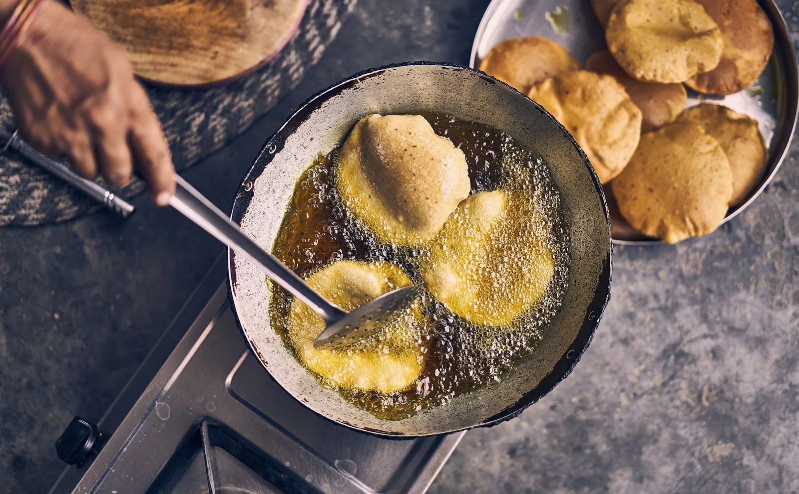 Rolled tortillas frying until golden
