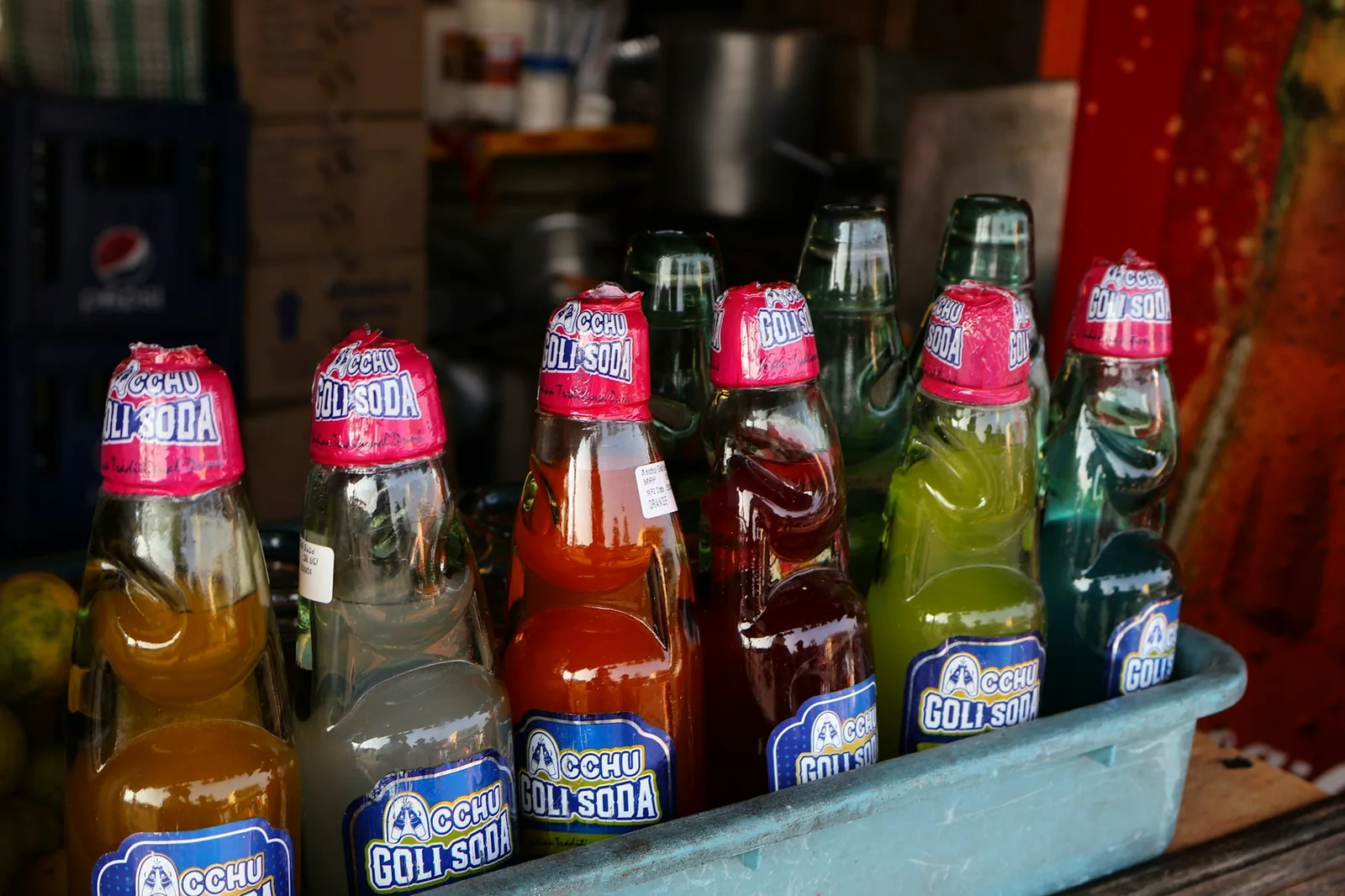 Barrel jars of aguas frescas lined up at a drinks stand