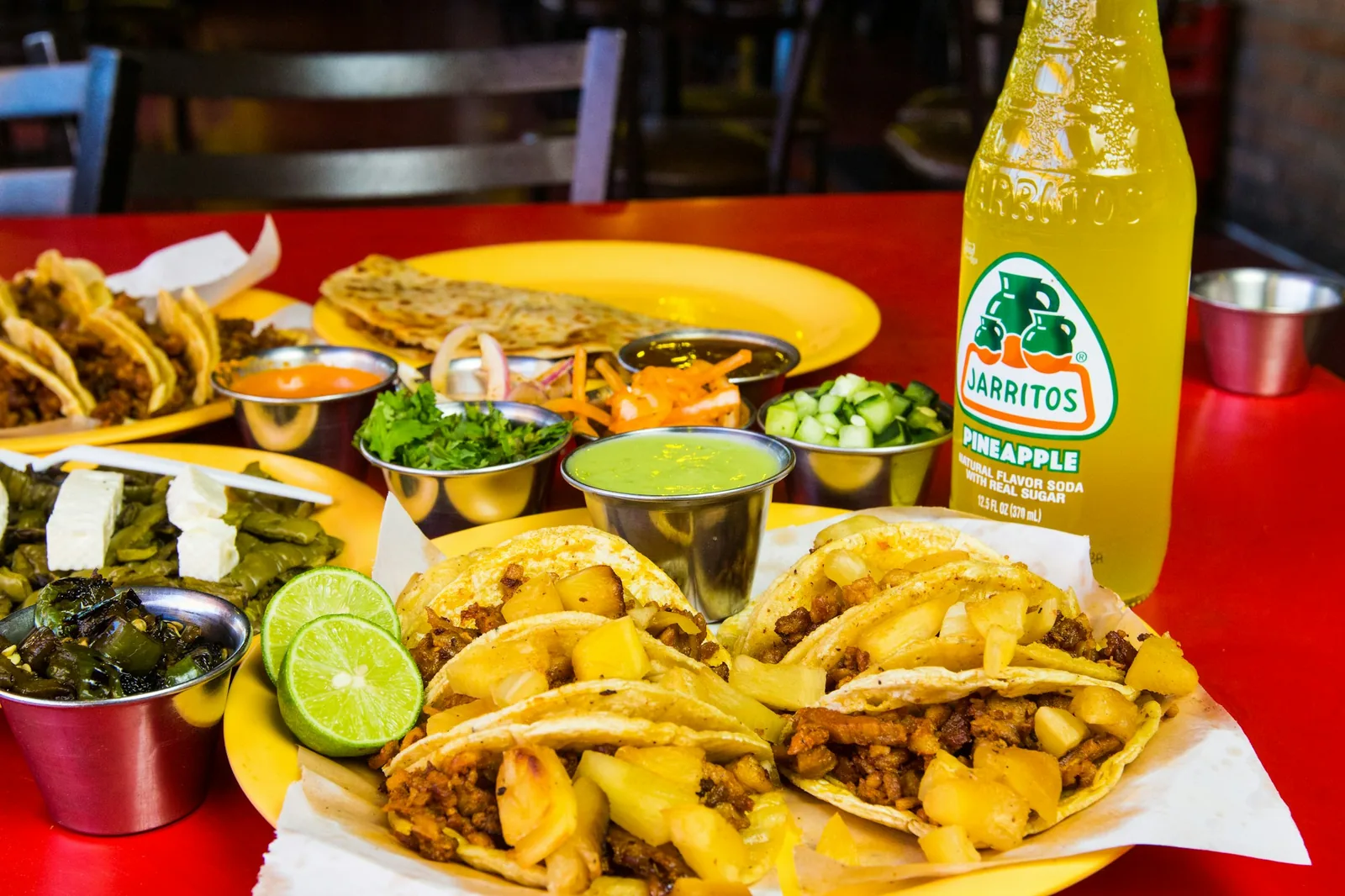 A taqueria table set with condiments and limes