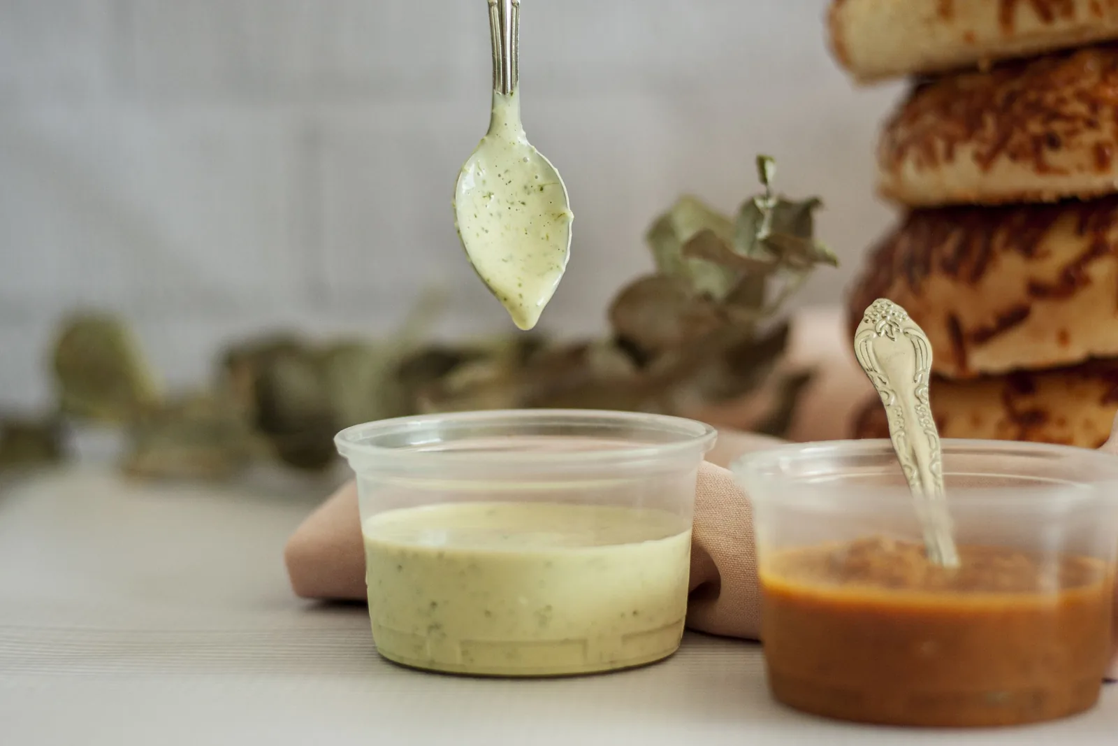 Tasting a sauce from a spoon before committing