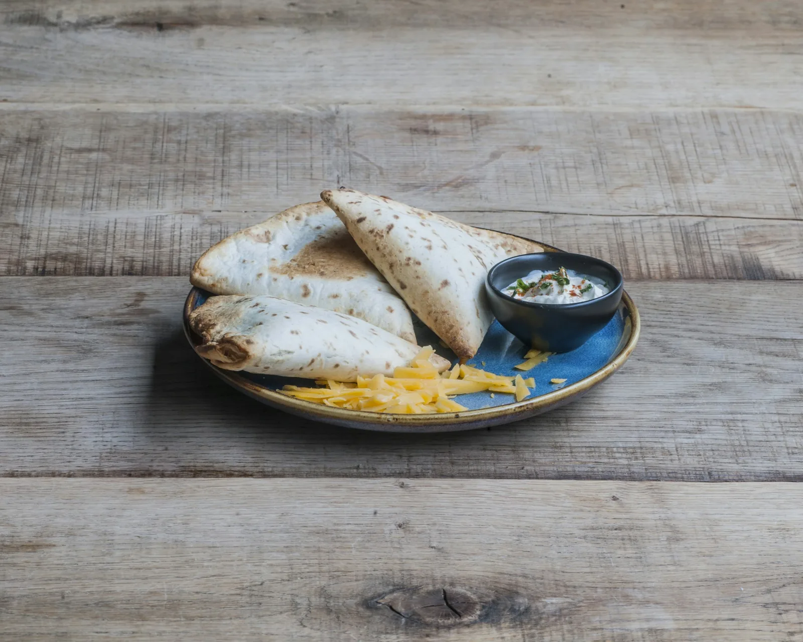A plain cheese quesadilla cut into triangles