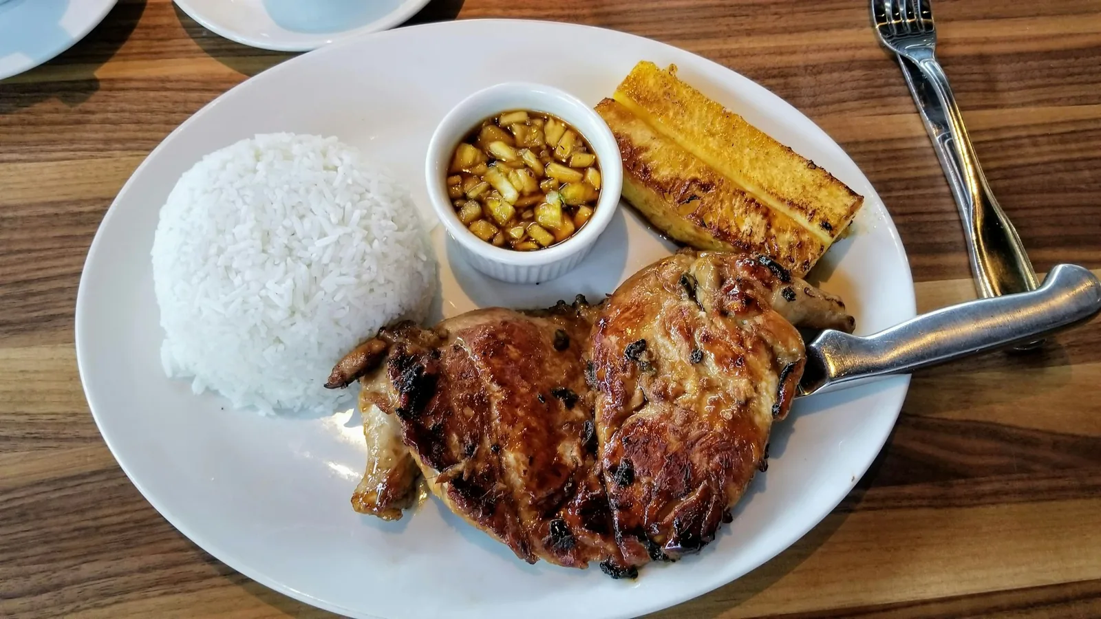 A simple plate of chicken, rice and beans