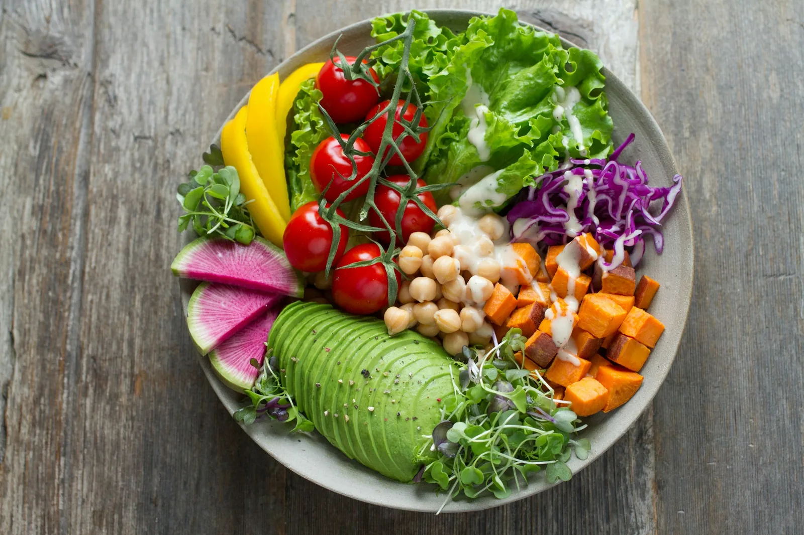 A large bowl of salad greens and vegetables