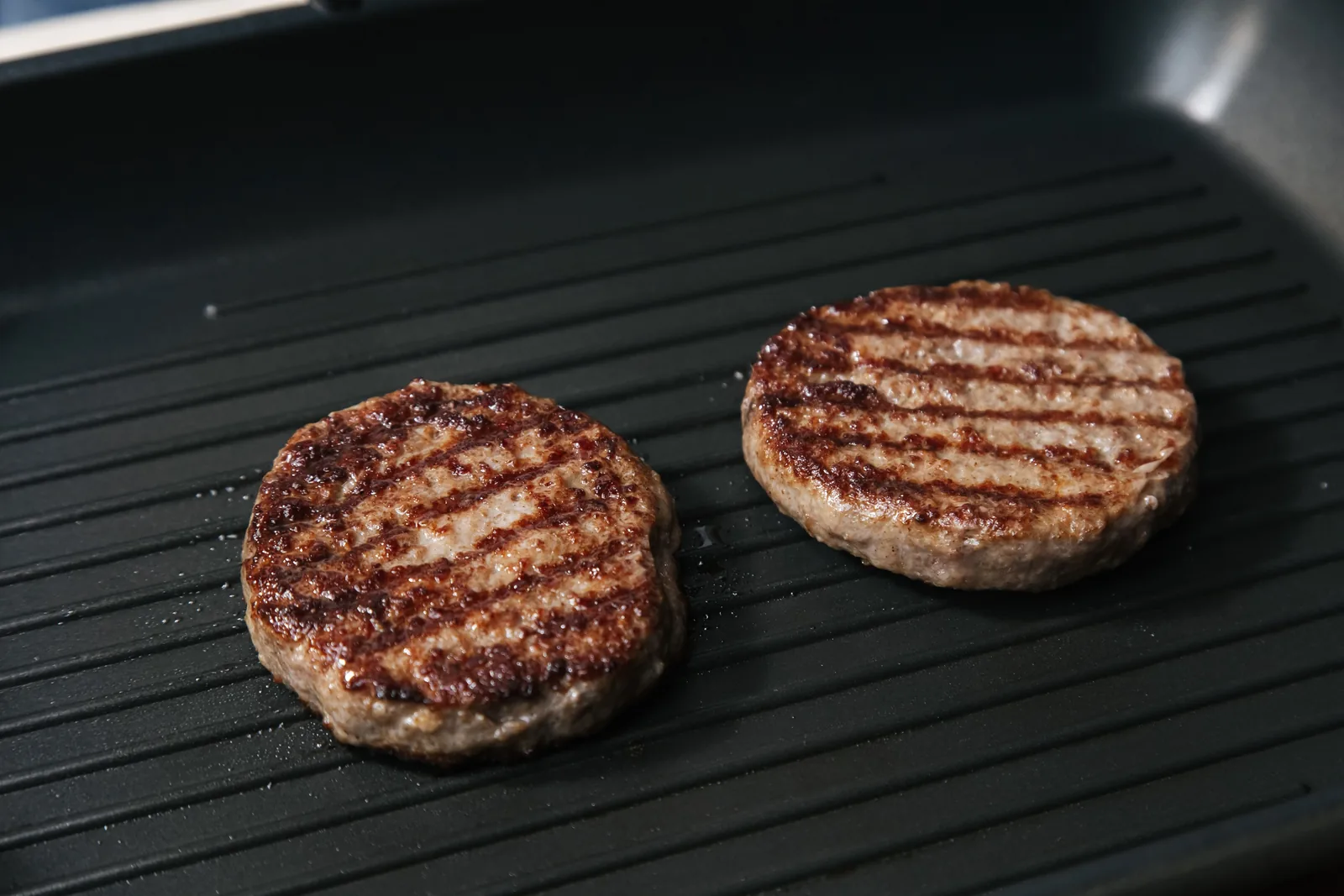Meat crisping on a hot flat griddle