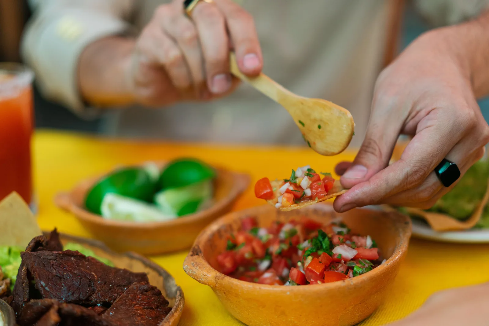 Salsas and lime set out on a taqueria table