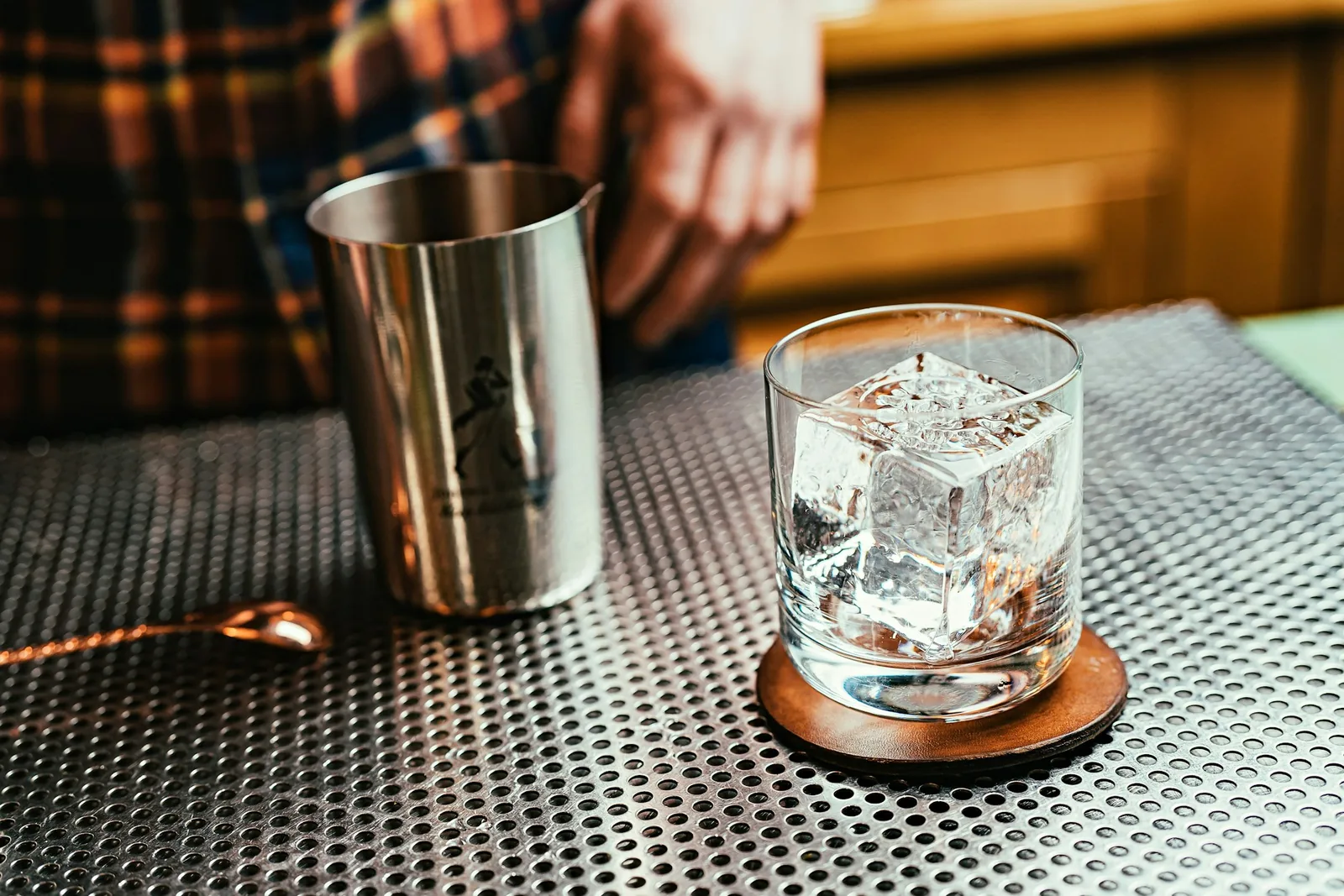 A clear spirit being measured into a shaker