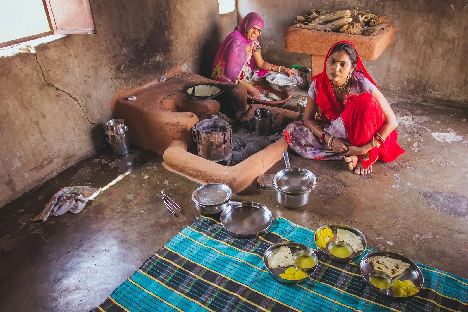 Cooks working together over a traditional kitchen fire