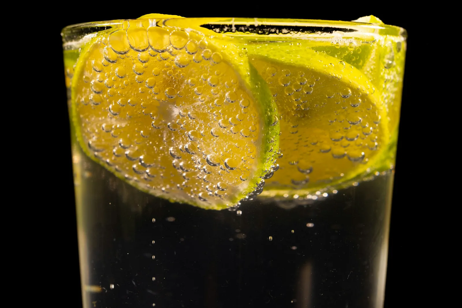 Lime being squeezed into a drink