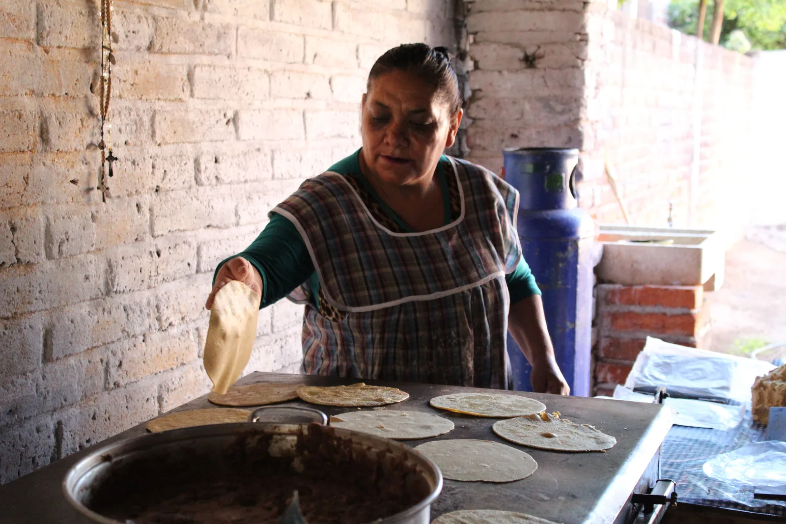Fresh corn tortillas on a griddle