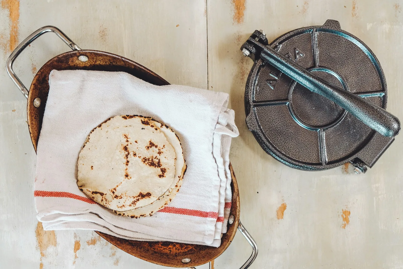 Dough being flattened in a tortilla press
