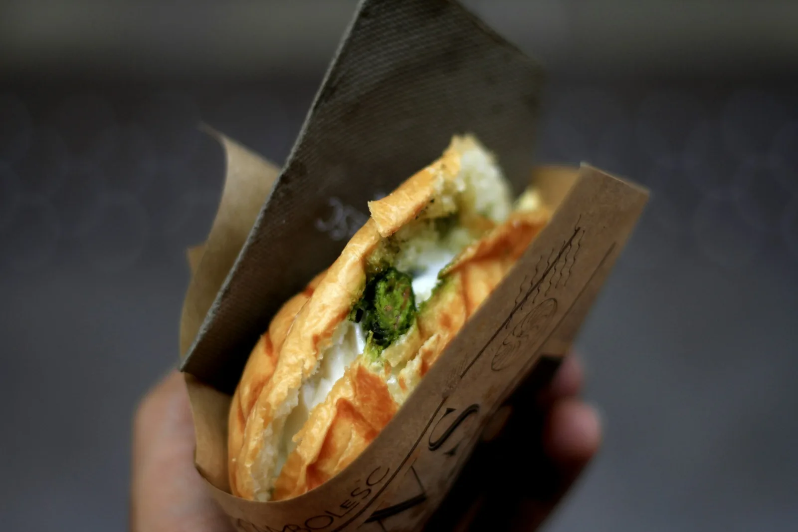 A steamed masa parcel served inside a bread roll