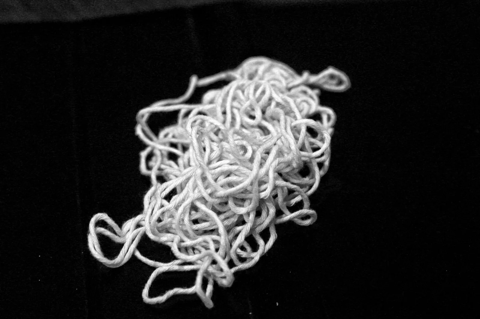 A ball of stretched, rope-wound white cheese