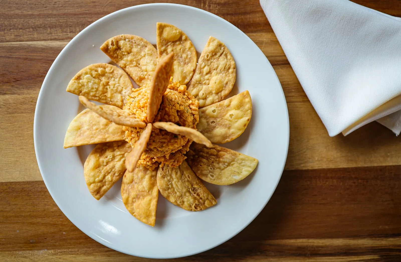 Small fried masa rounds topped with salsa