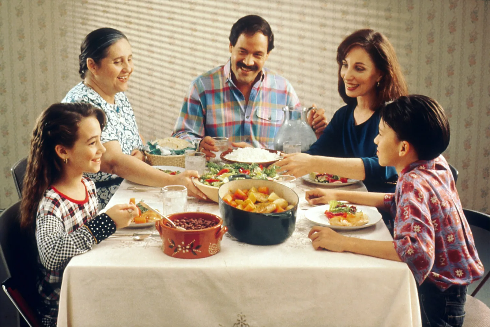 A table of people sharing bowls of soup