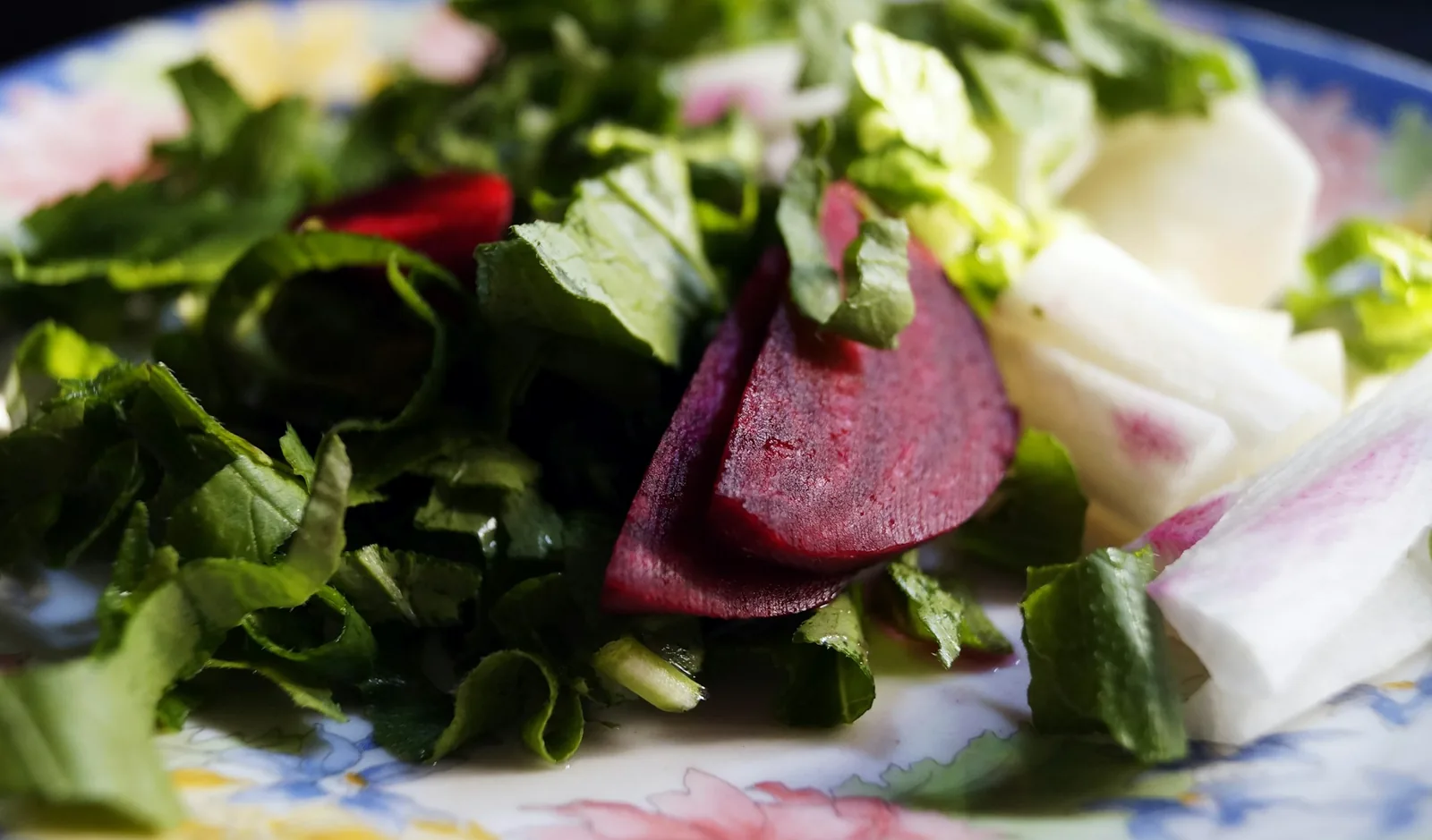 Shredded cabbage, radish, lime and oregano set out as garnishes