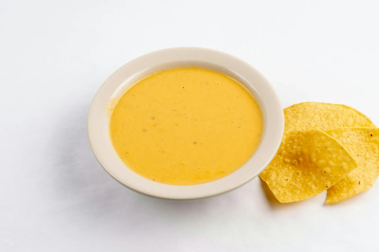 A smooth cheese dip served with tortilla chips