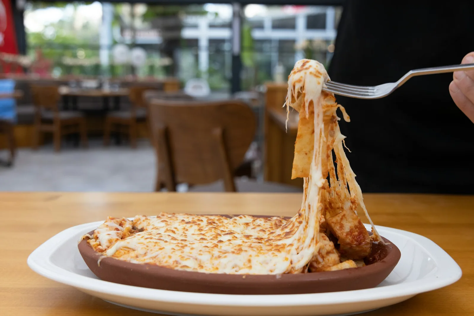 Melted cheese stretching from a skillet
