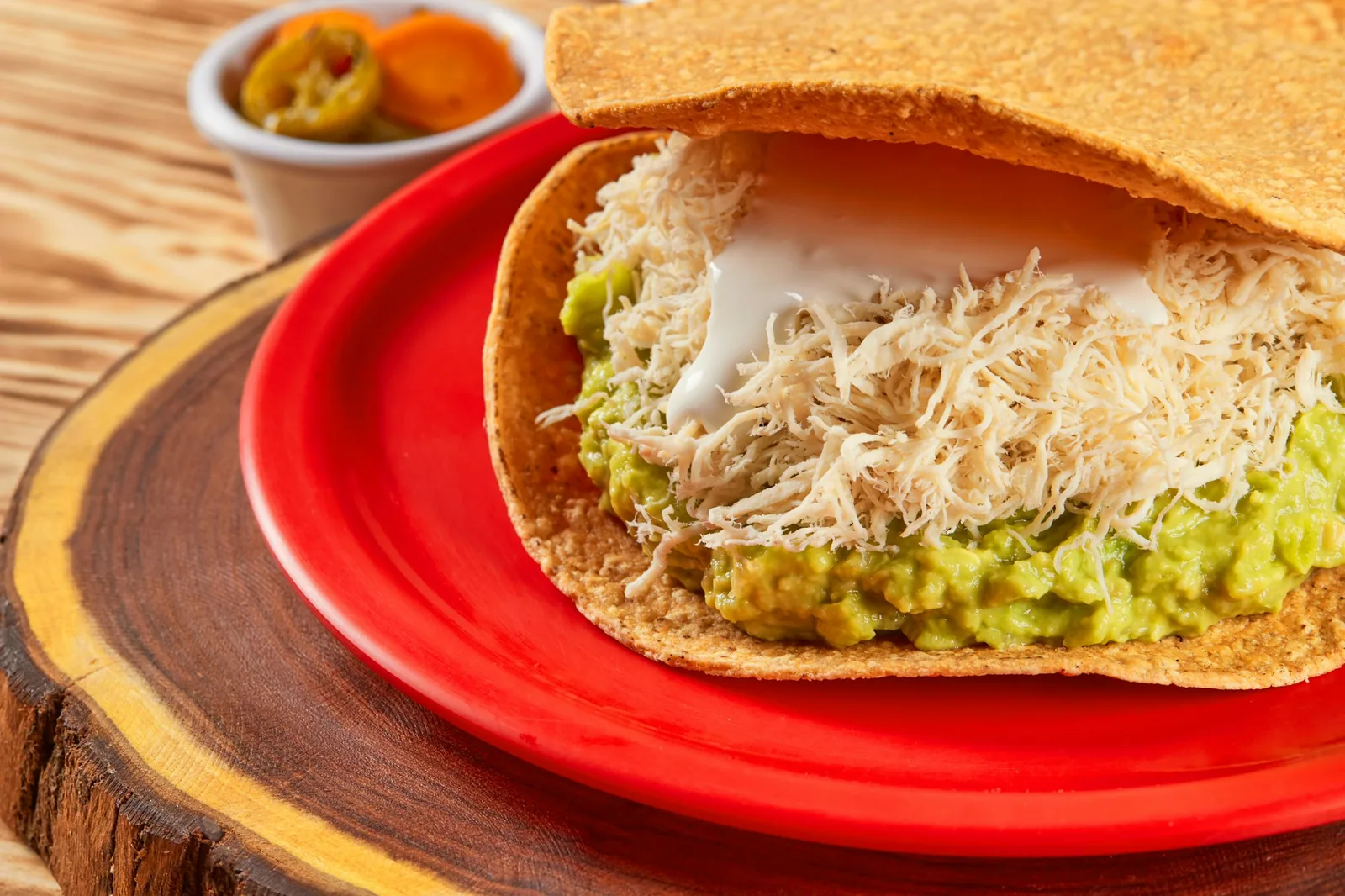 Beans spread as a base layer on a crisp tortilla