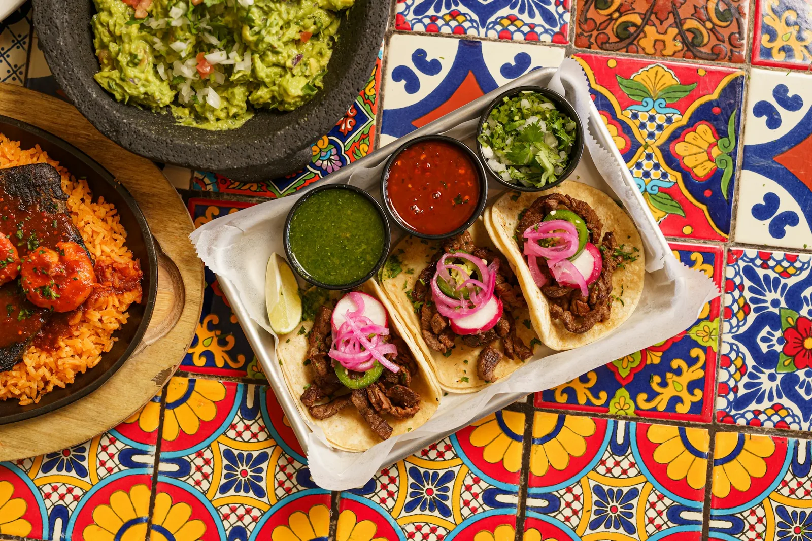 A shared table of Mexican dishes seen from above