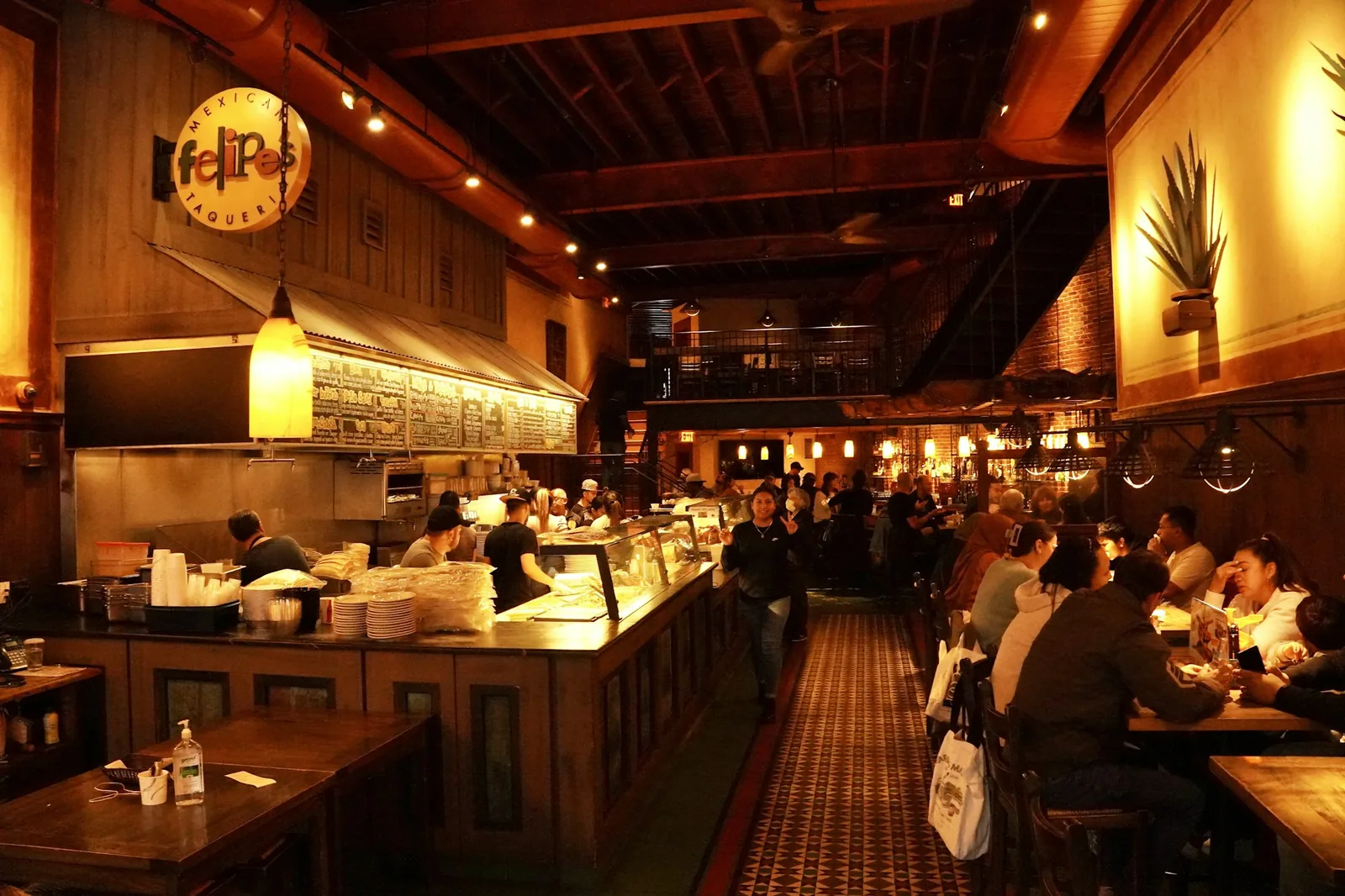 Customers ordering at a taqueria counter