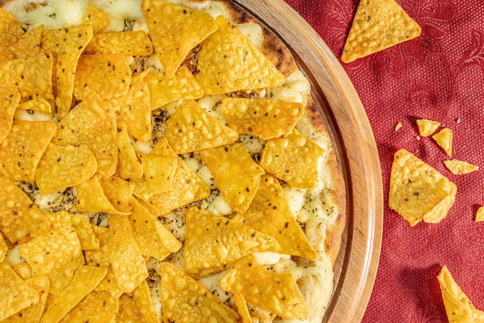 A flat tortilla baked crisp under melted cheese