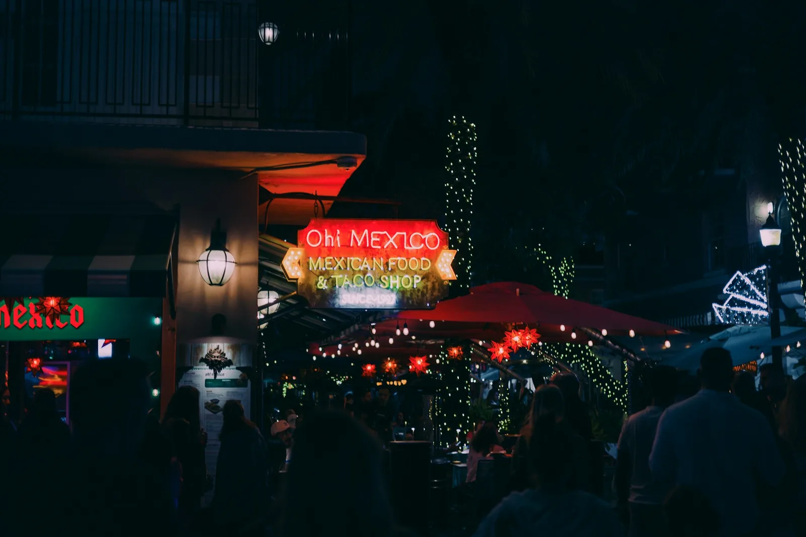 A taqueria street stall serving tacos in the evening