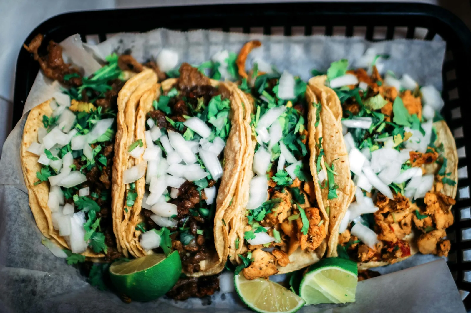 Three small street tacos topped only with onion and cilantro
