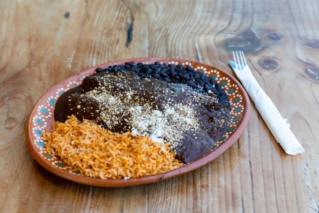 A Tex-Mex combination plate covered in melted cheese