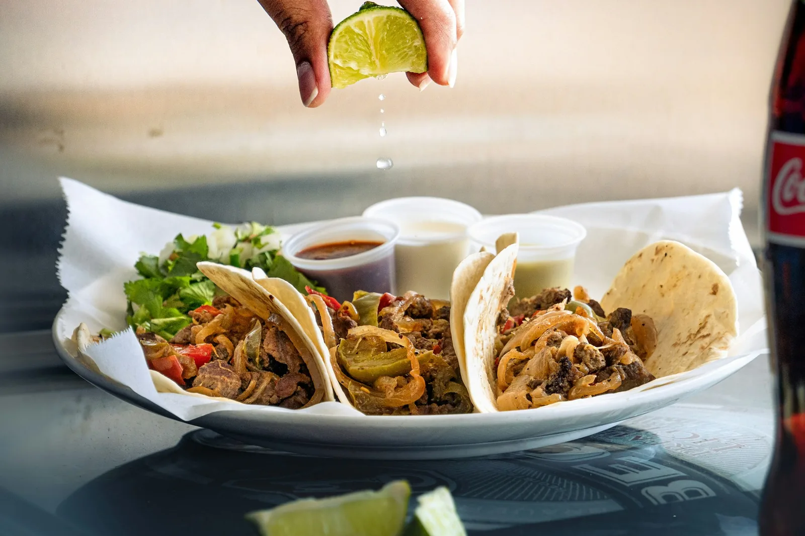 Lime being squeezed over a taco