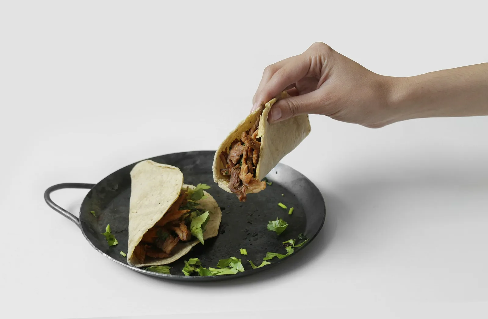 A taco filled with cooked mushrooms