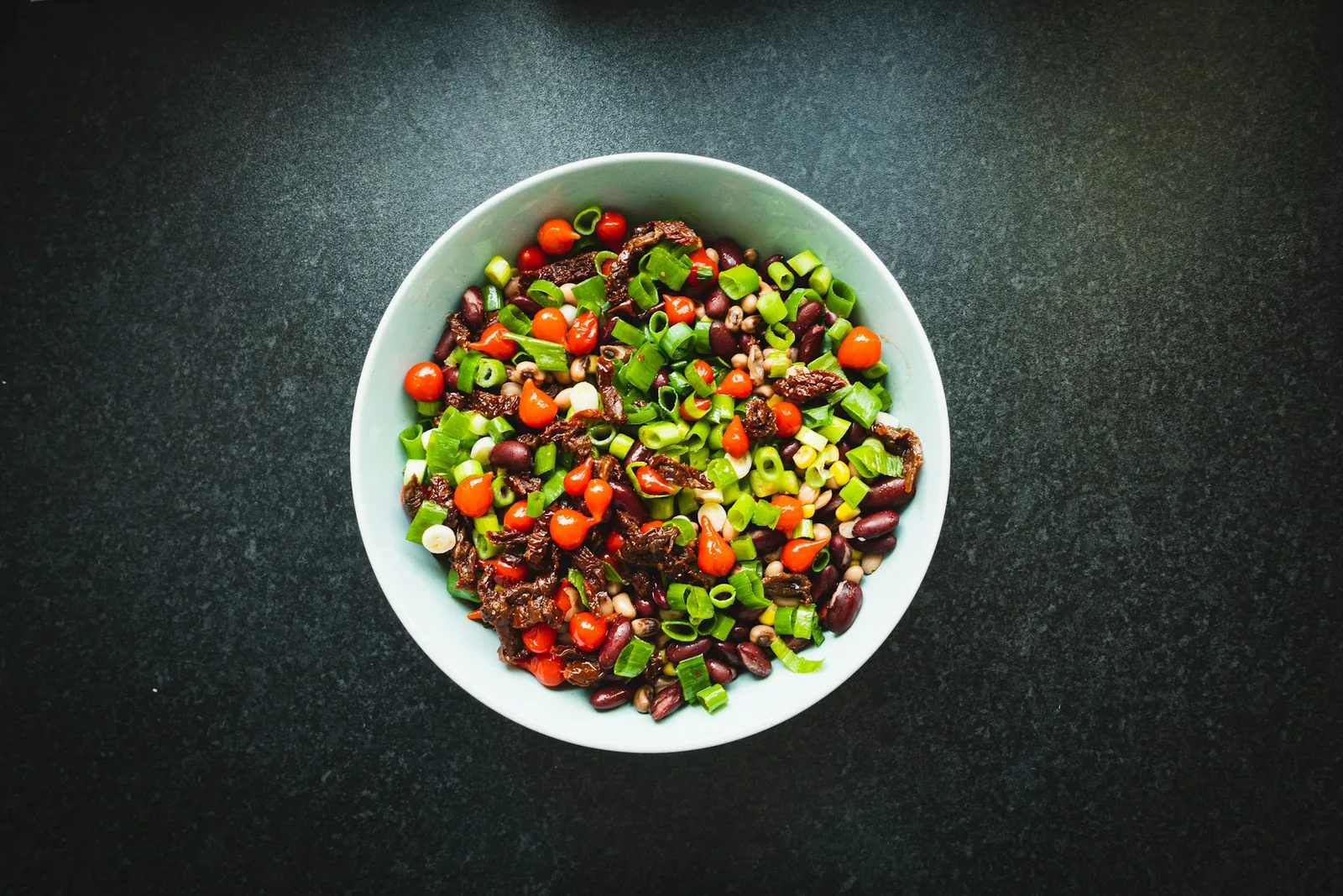 A spread of vegetables, beans and salsas